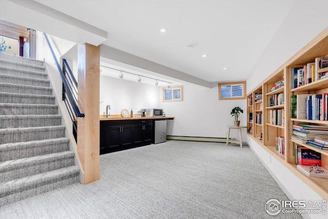 interior space with stairs, indoor wet bar, baseboard heating, light colored carpet, and recessed lighting