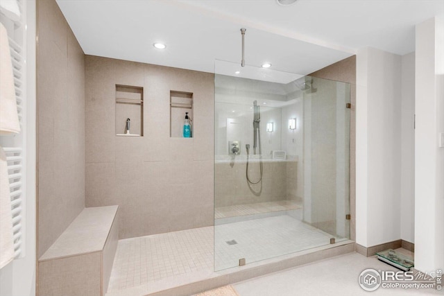 bathroom featuring radiator heating unit, tile patterned floors, a stall shower, and recessed lighting
