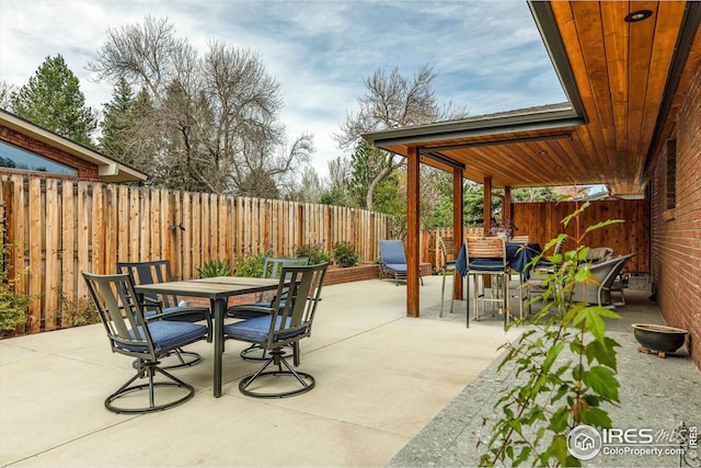 view of patio with outdoor dining area and a fenced backyard