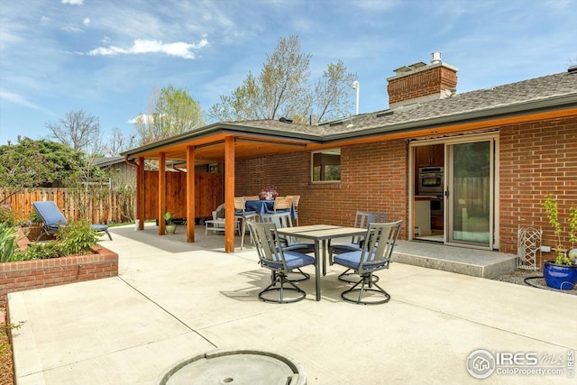 view of patio / terrace featuring fence and outdoor dining area