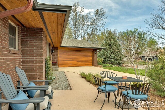 view of patio featuring a garage and driveway