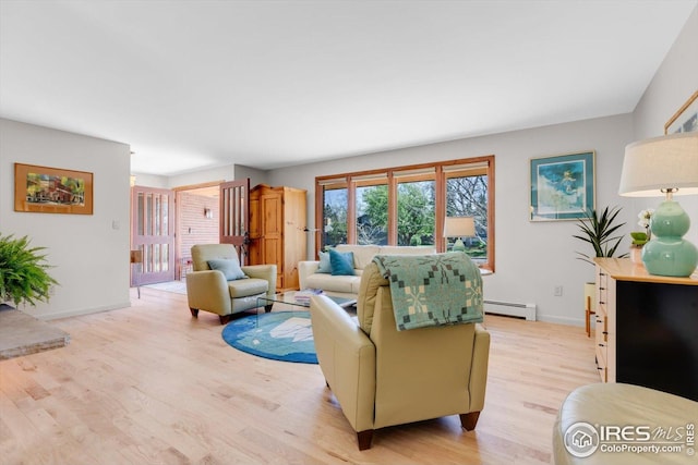 living room with light wood-style floors, baseboards, and baseboard heating