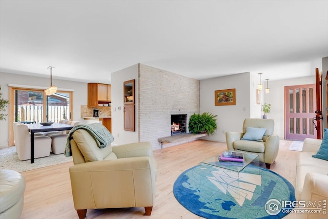 living room with light wood-type flooring and a fireplace