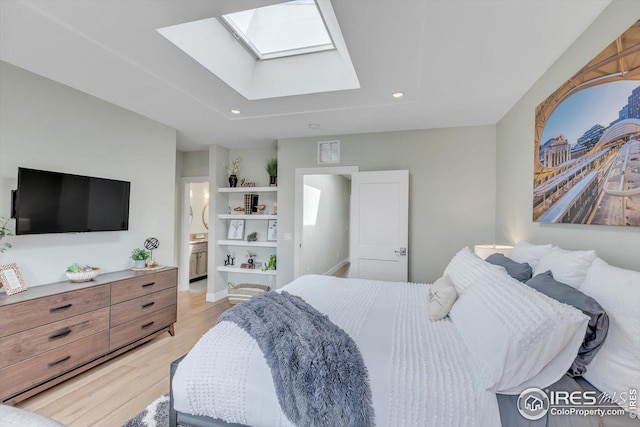 bedroom with visible vents, a skylight, connected bathroom, light wood-style floors, and recessed lighting
