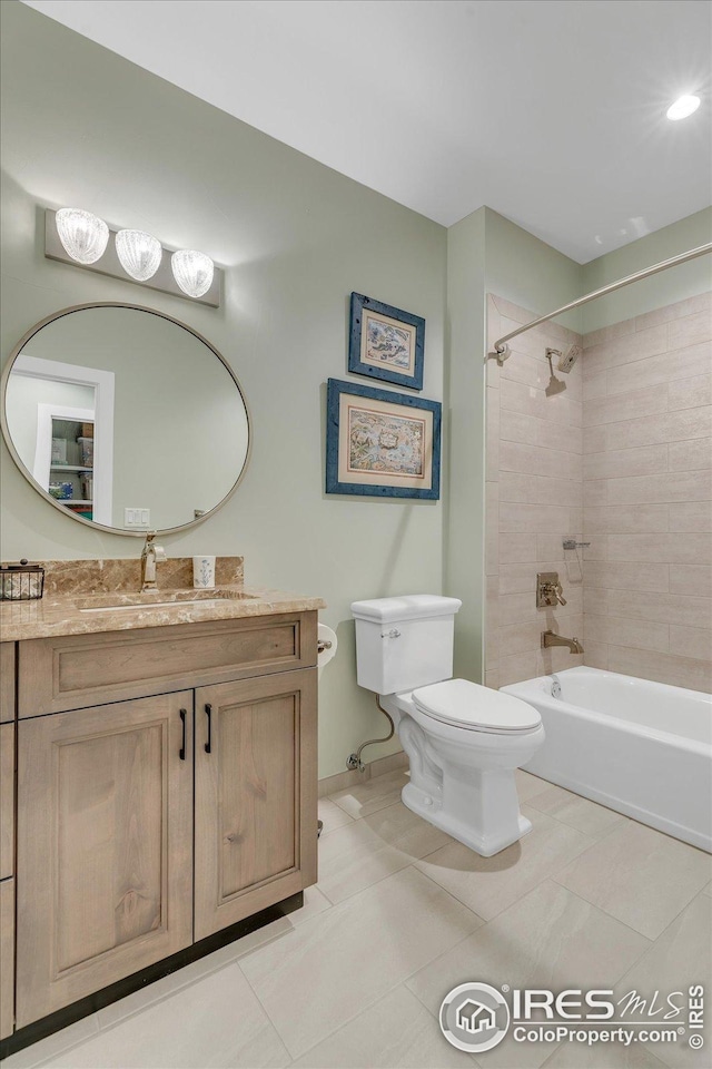 full bathroom featuring vanity, tile patterned flooring, toilet, baseboards, and shower / bath combination