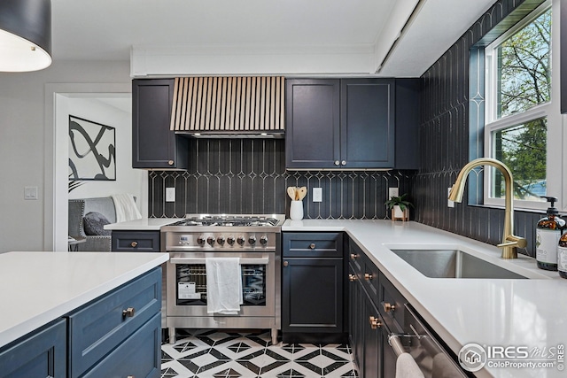kitchen with tasteful backsplash, stainless steel stove, a sink, light countertops, and extractor fan