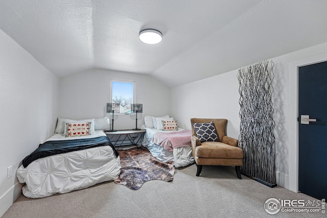 carpeted bedroom with vaulted ceiling
