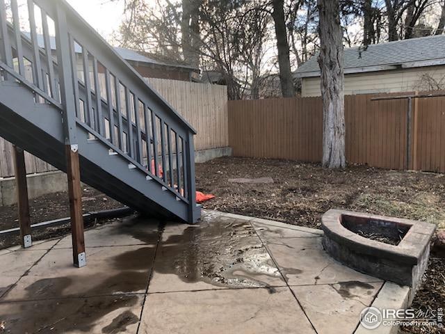 view of patio with fence and an outdoor fire pit