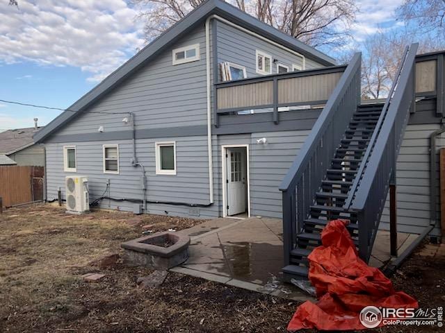 back of house featuring stairway, fence, ac unit, and a patio area