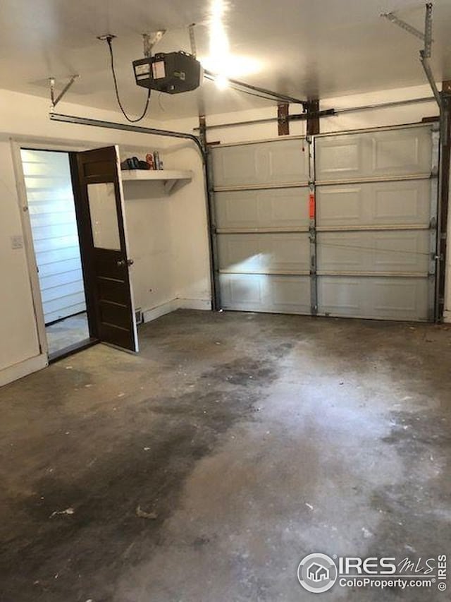 garage with baseboards and a garage door opener