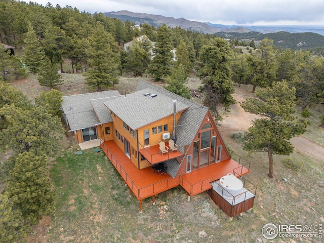 bird's eye view with a mountain view and a wooded view