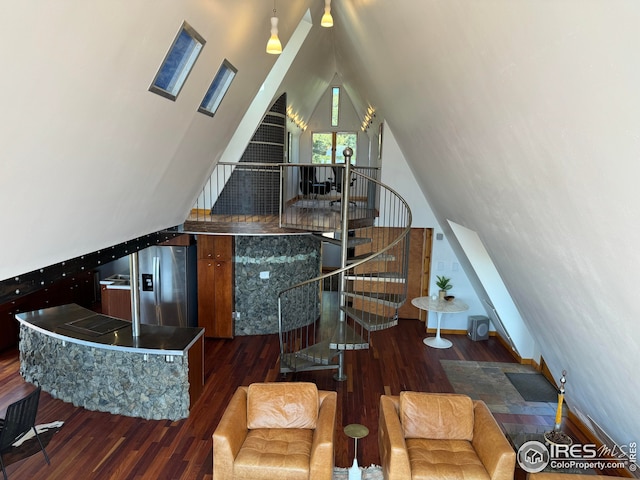 staircase featuring wood finished floors and lofted ceiling