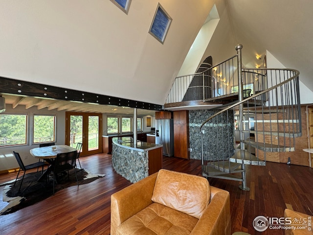 living room with high vaulted ceiling, dark wood-style flooring, and stairs