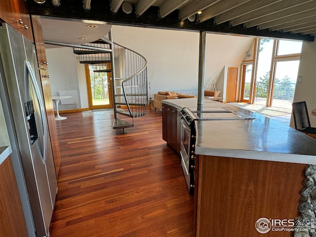 kitchen with appliances with stainless steel finishes, brown cabinets, and dark wood-style floors