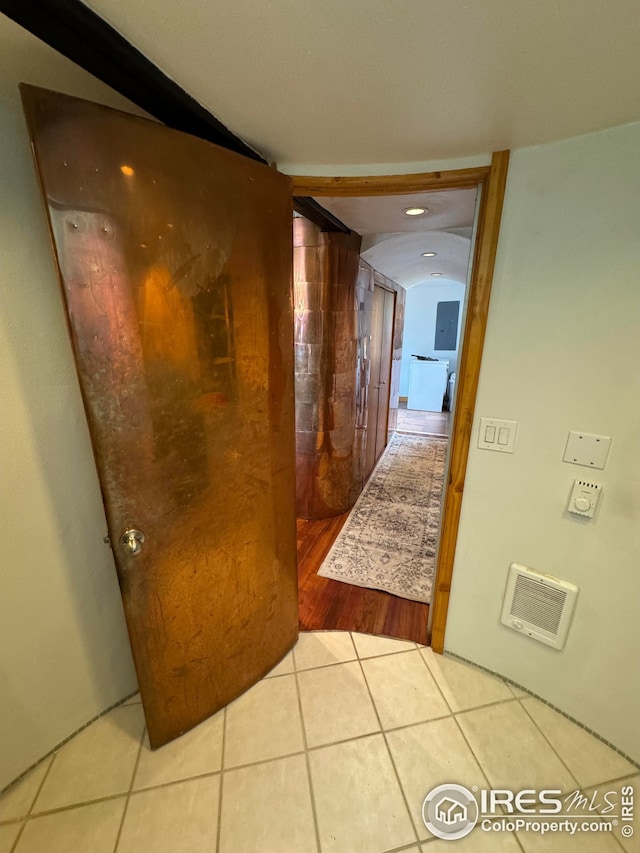 hall with visible vents and light tile patterned floors