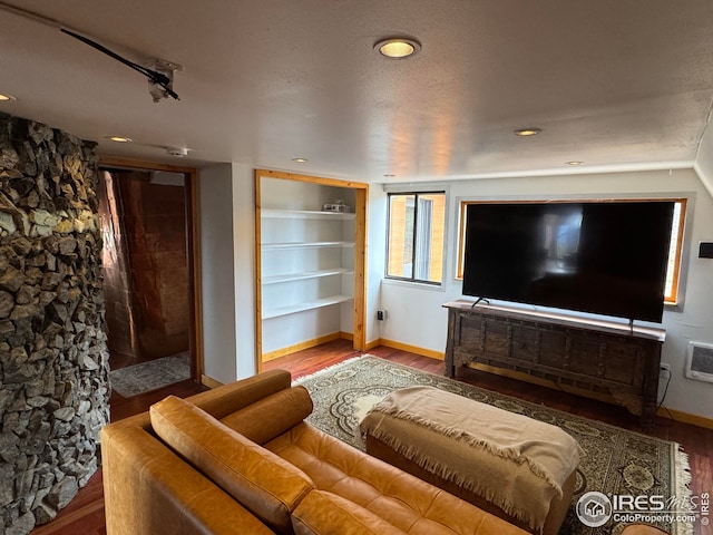living room with baseboards, recessed lighting, built in features, and wood finished floors