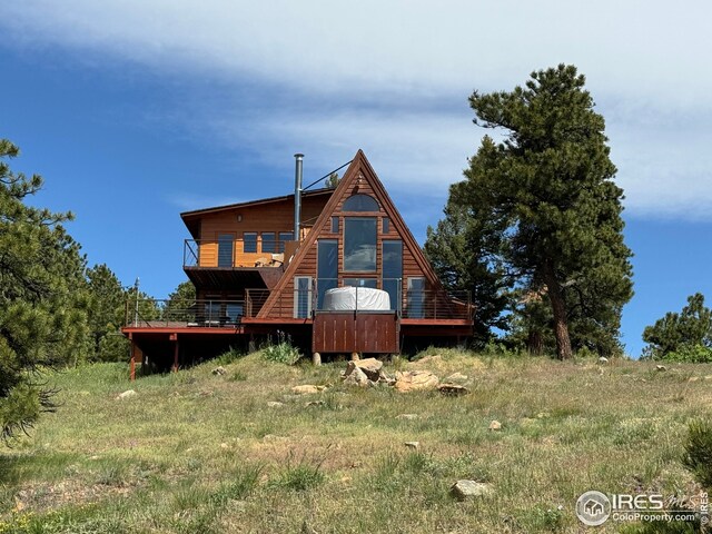 rear view of property with a wooden deck