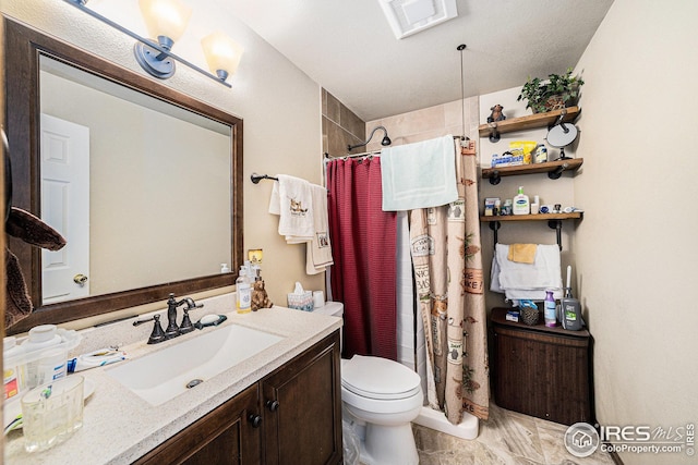 bathroom featuring toilet, visible vents, a shower with shower curtain, and vanity