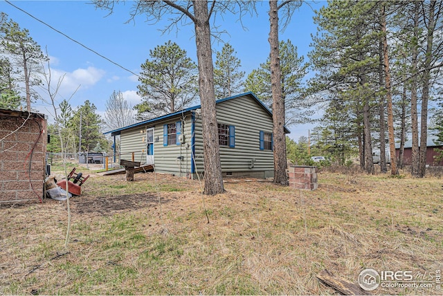 view of home's exterior featuring faux log siding and crawl space
