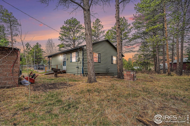 view of side of home with crawl space and faux log siding