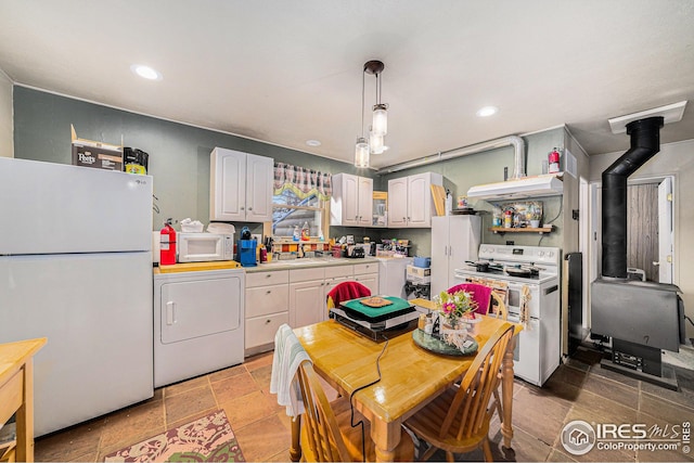 kitchen featuring white appliances, recessed lighting, washer / clothes dryer, and light countertops