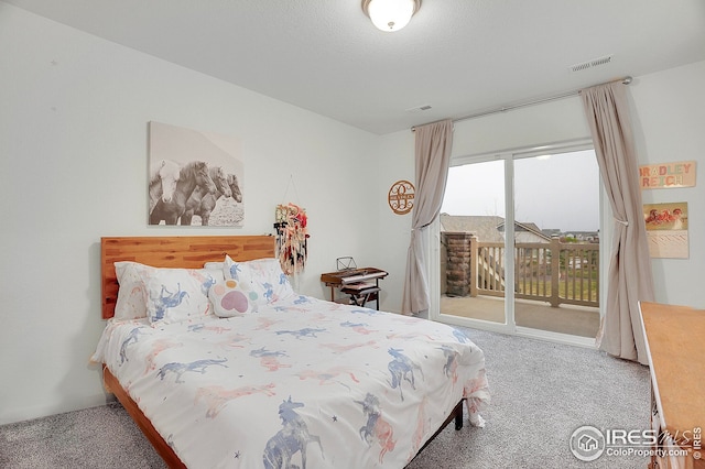 carpeted bedroom with access to outside and visible vents
