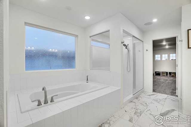 full bath featuring a bath, recessed lighting, tiled shower, and marble finish floor
