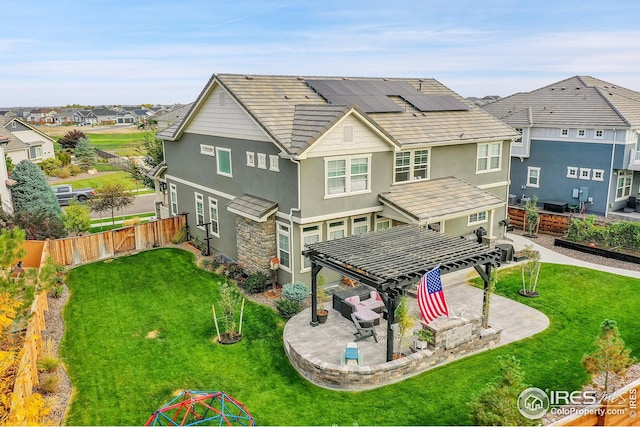 back of property with a fenced backyard, a pergola, stucco siding, and a lawn