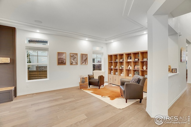 living area with recessed lighting, baseboards, and light wood-type flooring