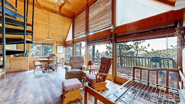 76 Cairn Ct, Drake, CO 80515 - sunroom / solarium with wood walls, hardwood / wood-style floors, high vaulted ceiling, and wooden ceiling
