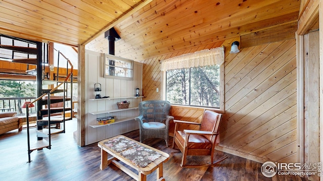76 Cairn Ct, Drake, CO 80515 - living area with stairway, plenty of natural light, wooden walls, and wood finished floors