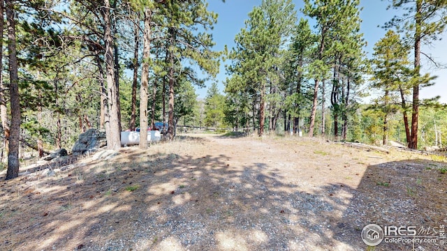 76 Cairn Ct, Drake, CO 80515 - view of yard featuring a wooded view