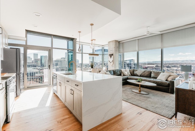 1700 Bassett St Unit 1808, Denver, CO 80202 - kitchen featuring a sink, a view of city, open floor plan, light wood-type flooring, and floor to ceiling windows