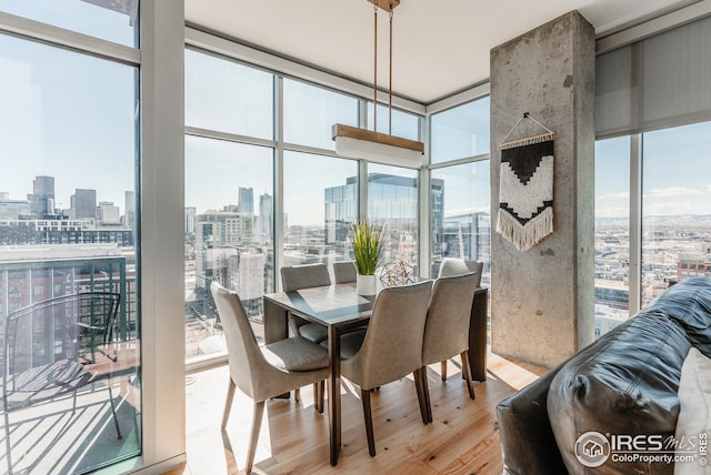 1700 Bassett St Unit 1808, Denver, CO 80202 - dining room featuring light wood-type flooring, a view of city, and a wall of windows