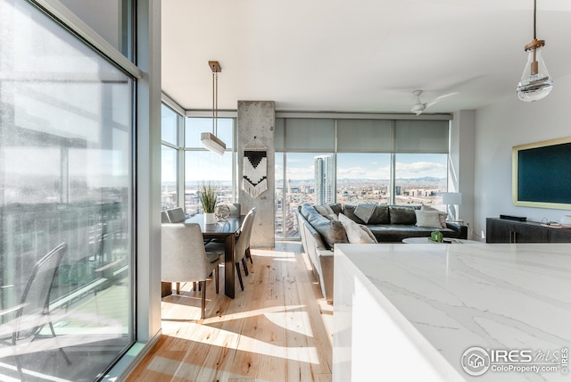 1700 Bassett St Unit 1808, Denver, CO 80202 - interior space featuring a wall of windows, a ceiling fan, and light wood-style flooring