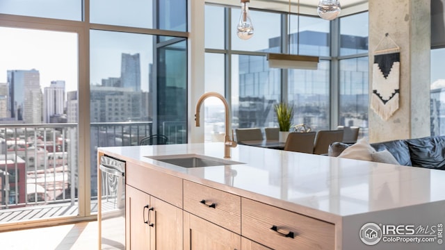 1700 Bassett St Unit 1808, Denver, CO 80202 - kitchen with light brown cabinetry, a city view, light countertops, a sink, and dishwasher