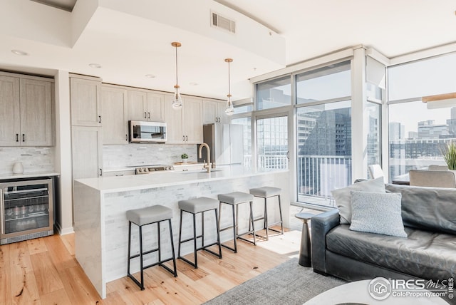 1700 Bassett St Unit 1808, Denver, CO 80202 - kitchen featuring visible vents, open floor plan, stainless steel microwave, and wine cooler