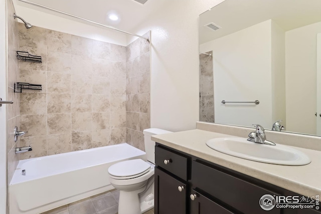 bathroom with visible vents, tile patterned flooring, shower / washtub combination, vanity, and toilet