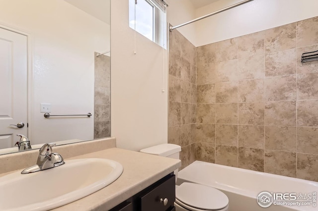 bathroom featuring toilet,  shower combination, and vanity