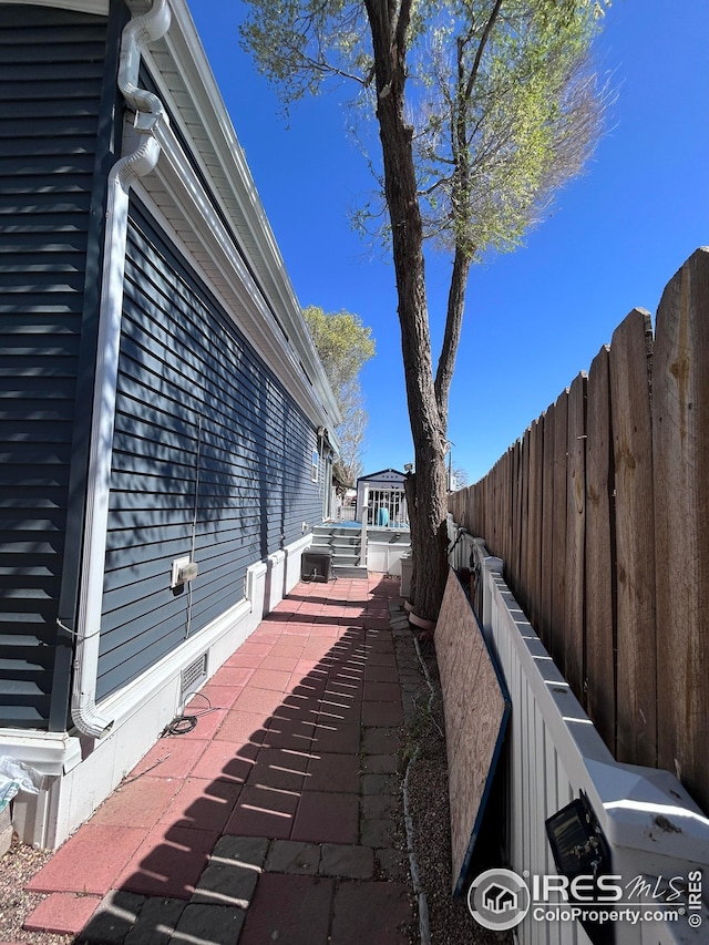 view of property exterior featuring a fenced backyard and a patio area