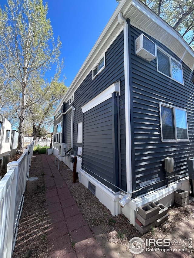 view of home's exterior with fence