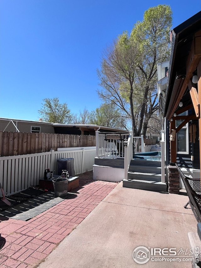 view of patio / terrace with fence and a wooden deck