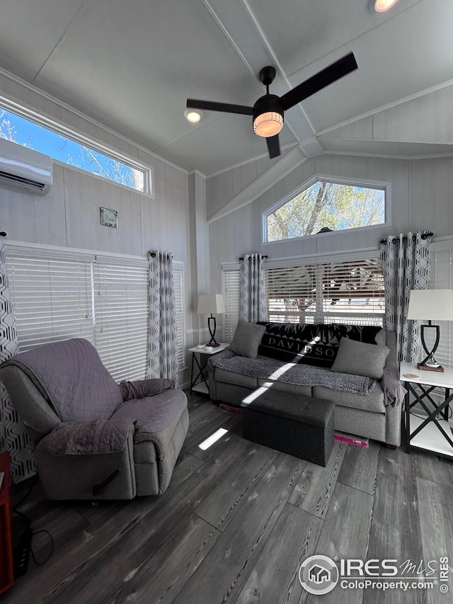 living area with plenty of natural light, ceiling fan, a wall mounted air conditioner, wood finished floors, and lofted ceiling