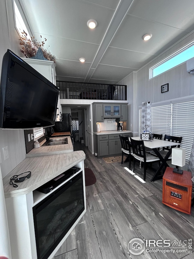interior space with light countertops, gray cabinets, and dark wood-style floors