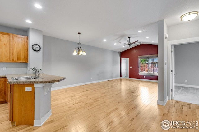 kitchen with light wood-type flooring, a sink, ceiling fan, and lofted ceiling