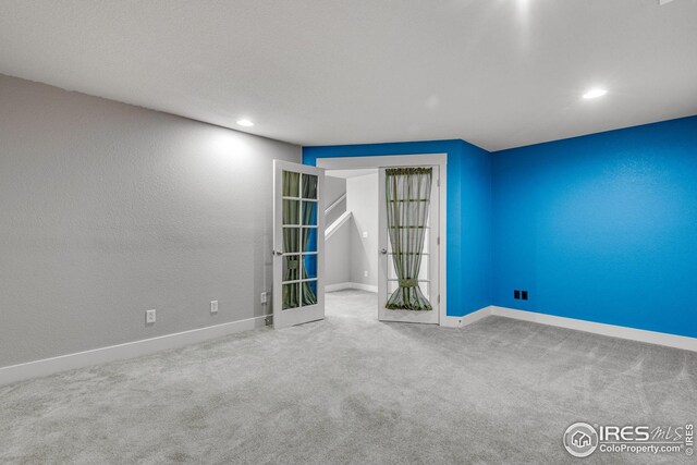 carpeted empty room with baseboards and recessed lighting