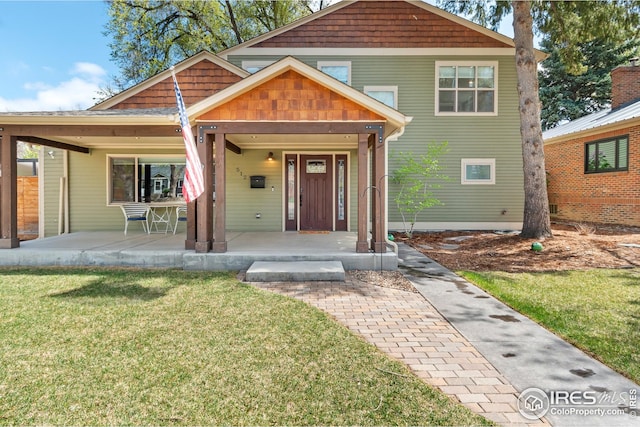 craftsman-style house featuring a porch and a front yard
