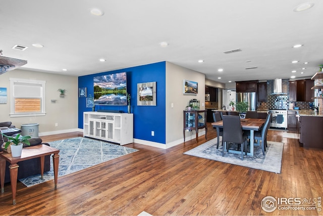 dining area with recessed lighting, baseboards, visible vents, and wood finished floors