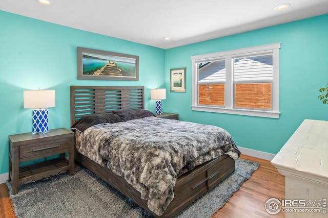 bedroom with recessed lighting, baseboards, and wood finished floors