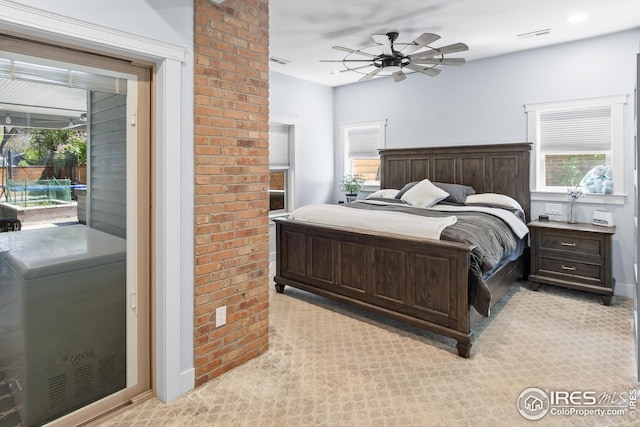 bedroom with access to outside, ceiling fan, visible vents, and multiple windows